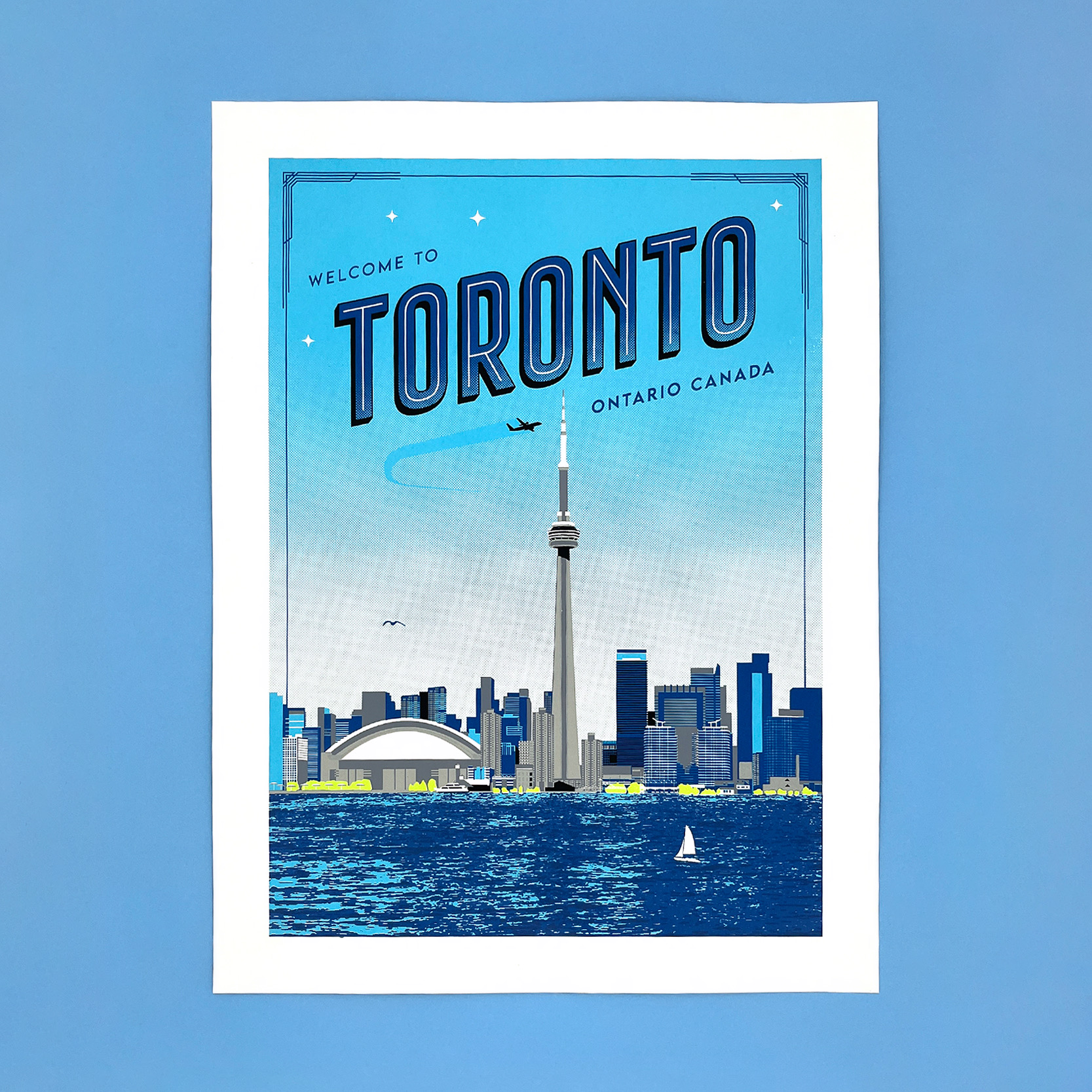 Kid Icarus hand screen printed print "Welcome to Toronto" illustrates the city's iconic skyline, featuring the CN Tower, Rogers Centre, etc